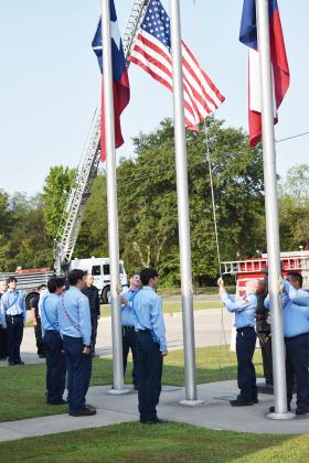 After the pledge, the cadets lower the flags.