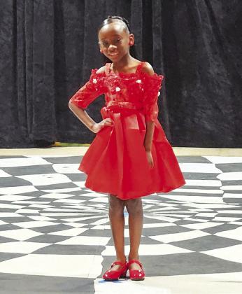 Intermediate Miss Juneteenth contestant Raquel Rogers, left, was dressed to impress in a showstopping red dress during the formalwear portion of the 2024 Miss Juneteenth Pageant.