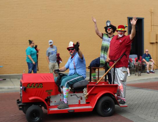 Sulphur Springs Fire Department's Fire Safety clowns wave to the crowd as they pass during the Dairy Festival Parade June 10.