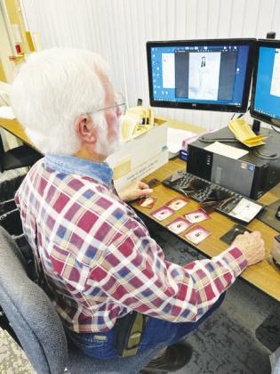 (Top right) Jerry Gregg volunteers by scanning photos into the archives at the Hopkins County Genealogical Society Research Library.