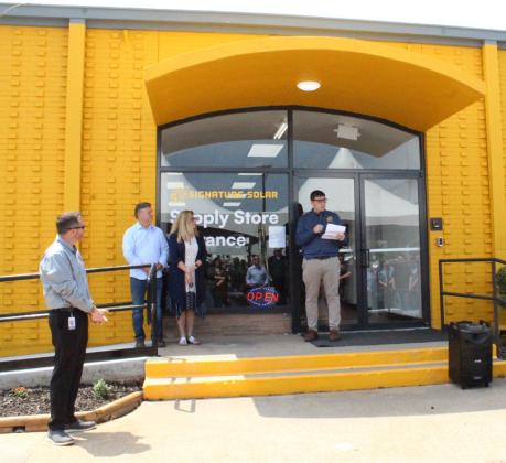 Signagure Solar CEO James Showalter welcomes everyone to the grand opening of the company's new location, inside the old VF Outlet and strip mall at 421 Industrial Drive on May 1. Staff photo by Faith Huffman